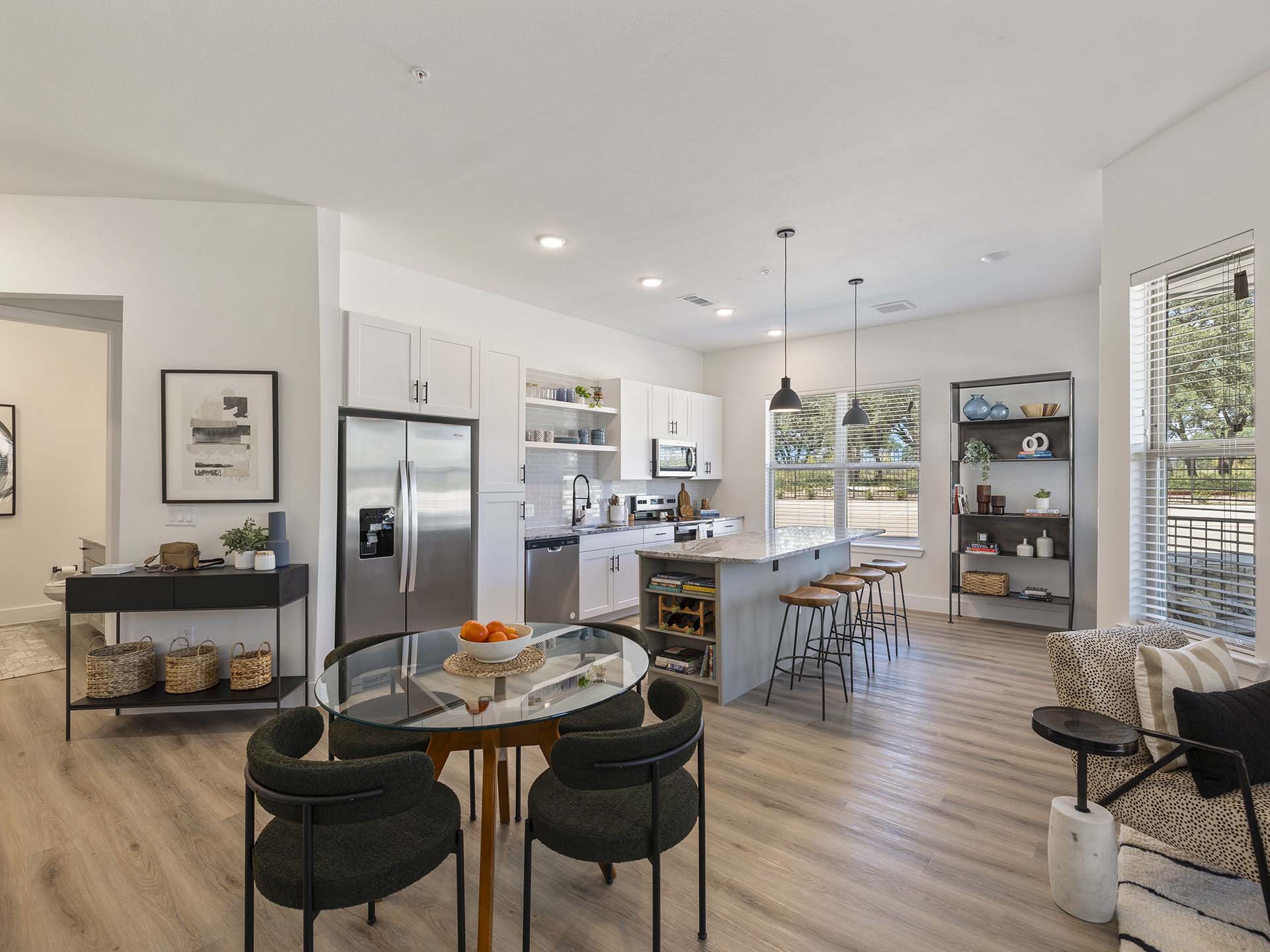 Open-concept living room and kitchen at The Evergrove apartments in Leander, Texas