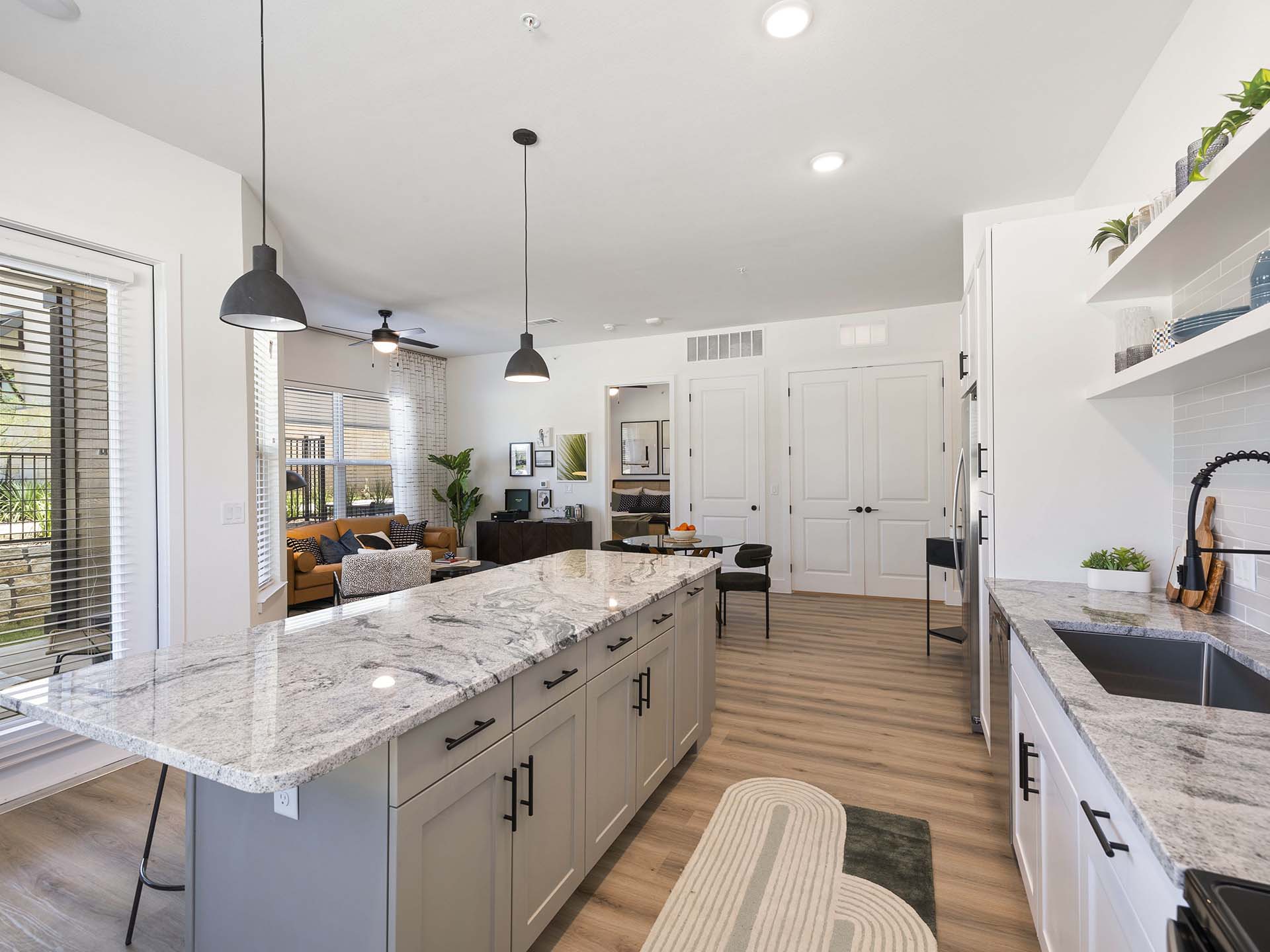 Evergrove apartment kitchen with wood style floor and kitchen island.