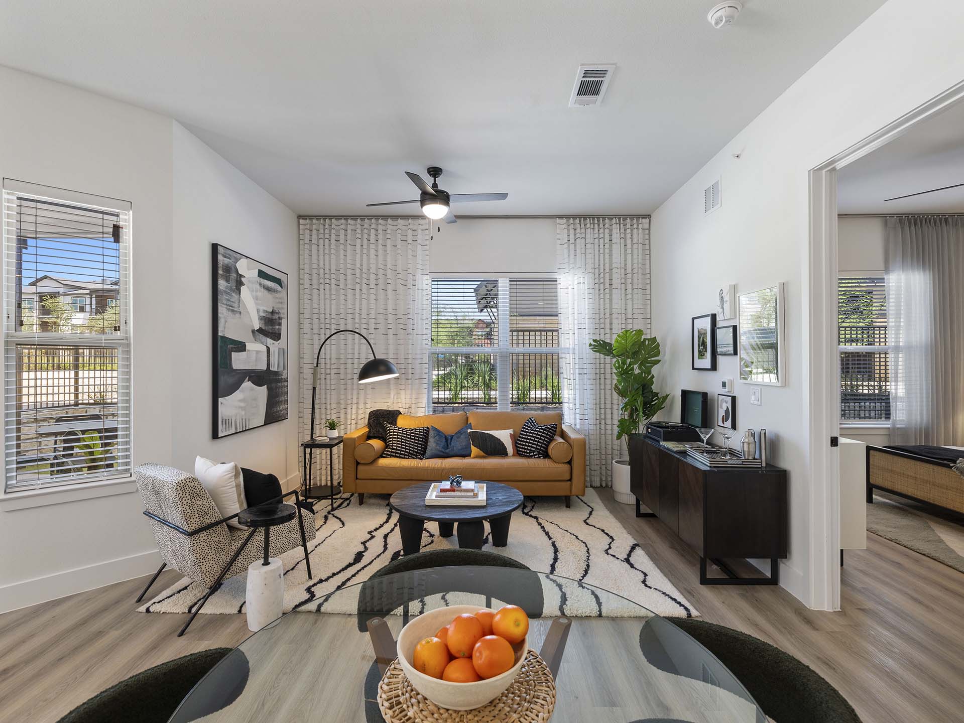 Evergrove apartment living room with wood style floor and plush seating.
